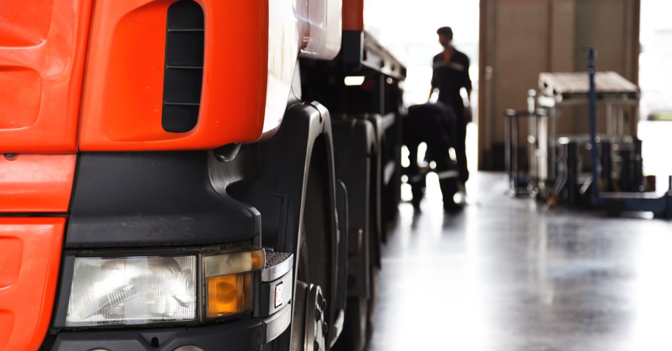 automobile mechanic checking truck in the garage, selective focus