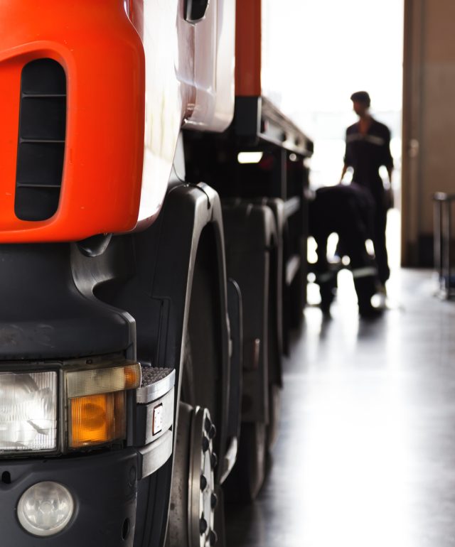 automobile mechanic checking truck in the garage, selective focus